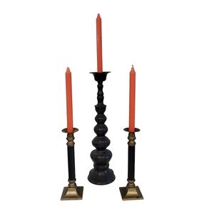3 black and gold candle sticks with orange candles. Gothic halloween